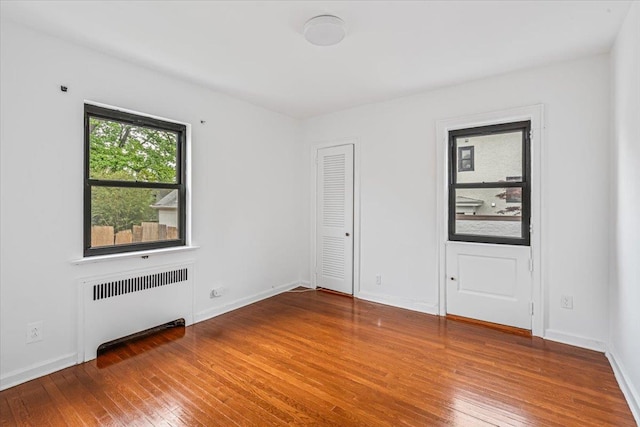 164-03 33rd Ave, Flushing, NY 11358 - spare room with radiator, hardwood / wood-style flooring, and baseboards