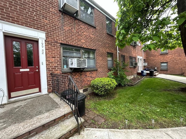 199-58 21st Ave Unit 1-165, Whitestone, NY 11357 - entrance to property featuring brick siding, cooling unit, and a lawn