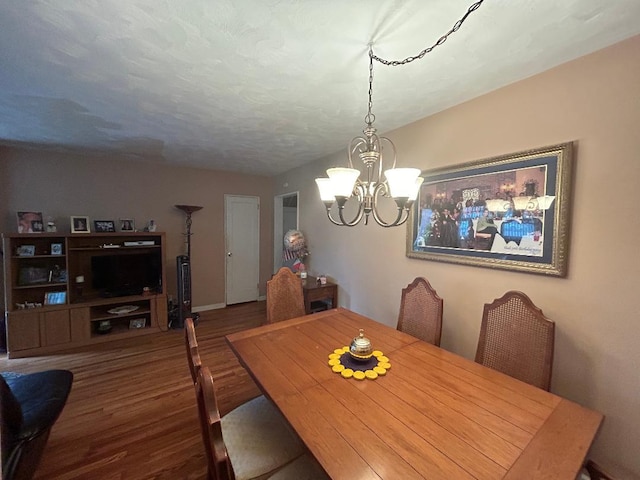 199-58 21st Ave Unit 1-165, Whitestone, NY 11357 - dining room featuring a chandelier, wood finished floors, and baseboards