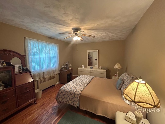 199-58 21st Ave Unit 1-165, Whitestone, NY 11357 - bedroom with radiator heating unit, wood finished floors, and ceiling fan