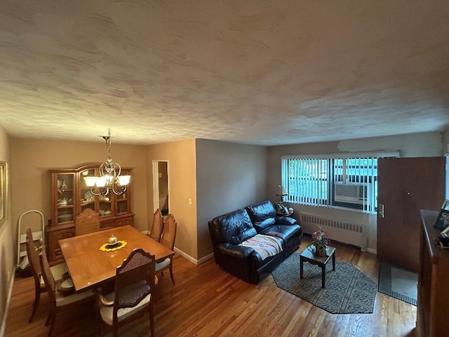199-58 21st Ave Unit 1-165, Whitestone, NY 11357 - dining space featuring radiator, a chandelier, wood finished floors, a textured ceiling, and baseboards