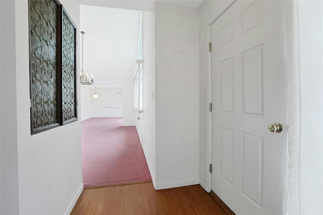 50 Parker Blvd, Monsey, NY 10952 - hall with a chandelier, baseboards, and wood finished floors