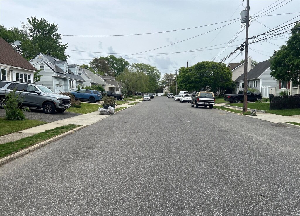 34 Karen St, West Babylon, NY 11704 - view of asphalt street featuring a residential view, sidewalks, and curbs