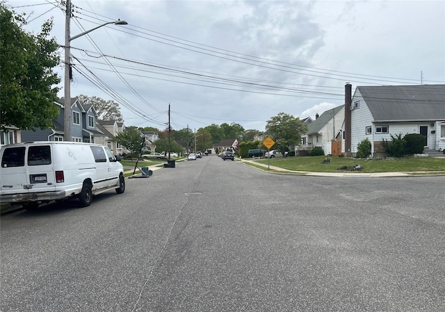 34 Karen St, West Babylon, NY 11704 - view of asphalt road featuring a residential view, traffic signs, and curbs