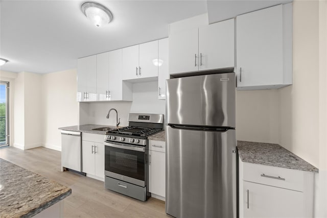 875 Morrison Ave Unit 6E, Bronx, NY 10473 - kitchen featuring stainless steel appliances, a sink, light wood-style floors, white cabinets, and baseboards