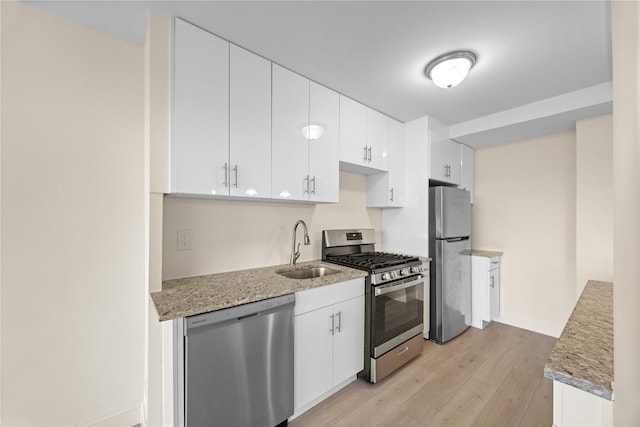 875 Morrison Ave Unit 6E, Bronx, NY 10473 - kitchen with stainless steel appliances, a sink, light wood finished floors, white cabinetry, and baseboards
