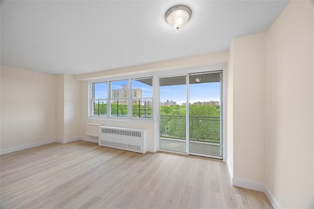 875 Morrison Ave Unit 6E, Bronx, NY 10473 - unfurnished room with radiator, light wood-type flooring, and baseboards