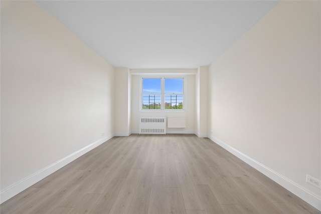875 Morrison Ave Unit 6E, Bronx, NY 10473 - empty room with radiator heating unit, light wood-style flooring, and baseboards