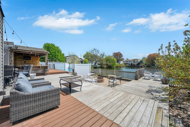 24 Raynor St, West Babylon, NY 11704 - wooden deck with a water view and an outdoor living space with a fire pit