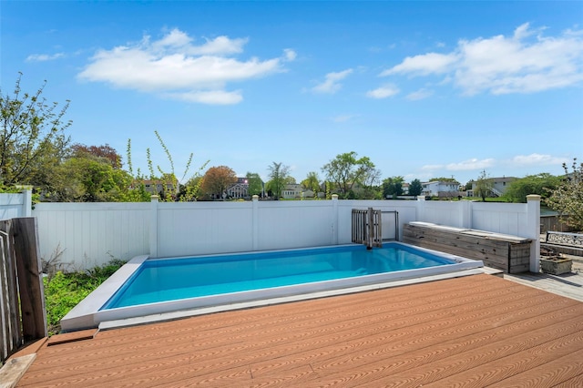 24 Raynor St, West Babylon, NY 11704 - view of swimming pool with a wooden deck and a fenced backyard