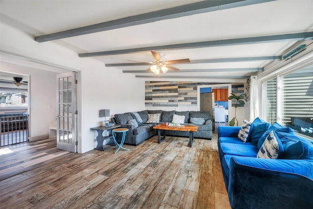 24 Raynor St, West Babylon, NY 11704 - living room featuring wood finished floors, ceiling fan, beamed ceiling, baseboards, and wooden walls