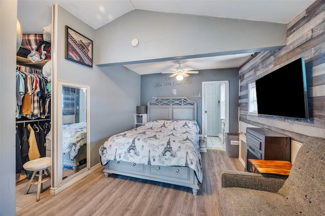 24 Raynor St, West Babylon, NY 11704 - bedroom featuring lofted ceiling, wood finished floors, a closet, a walk in closet, and baseboards