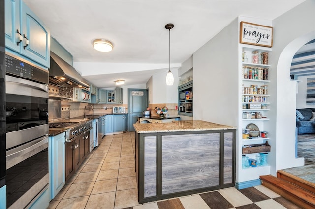 24 Raynor St, West Babylon, NY 11704 - kitchen with appliances with stainless steel finishes, arched walkways, dark stone countertops, exhaust hood, and pendant lighting