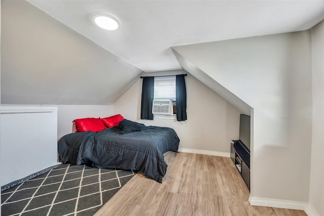 24 Raynor St, West Babylon, NY 11704 - bedroom featuring wood finished floors, baseboards, cooling unit, and vaulted ceiling