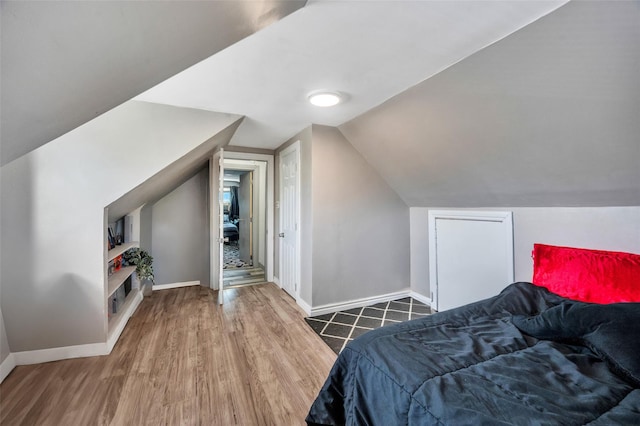 24 Raynor St, West Babylon, NY 11704 - bedroom with baseboards, wood finished floors, and lofted ceiling
