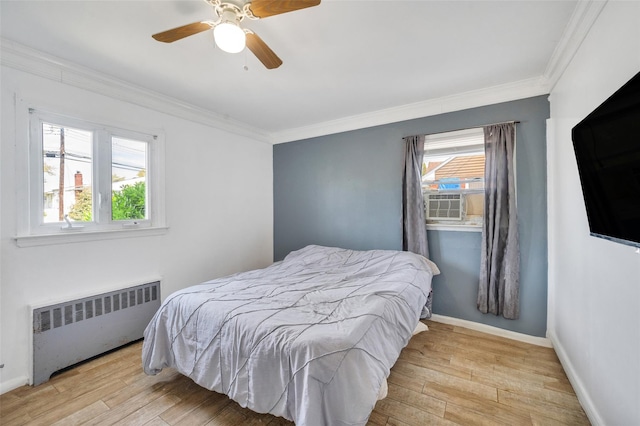 24 Raynor St, West Babylon, NY 11704 - bedroom featuring radiator heating unit, wood finished floors, crown molding, baseboards, and a ceiling fan