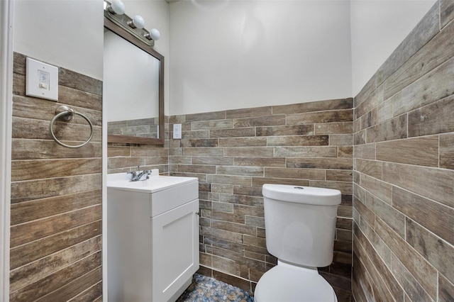 24 Raynor St, West Babylon, NY 11704 - bathroom with tile walls, vanity, toilet, and a wainscoted wall