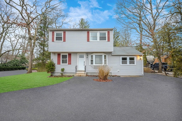 12 Barberry Ln, Middle Island, NY 11953 - colonial inspired home featuring a front yard and asphalt driveway