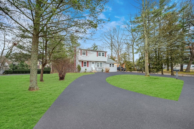 12 Barberry Ln, Middle Island, NY 11953 - colonial-style house with a front lawn and asphalt driveway