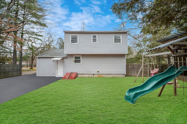 12 Barberry Ln, Middle Island, NY 11953 - rear view of property featuring a playground