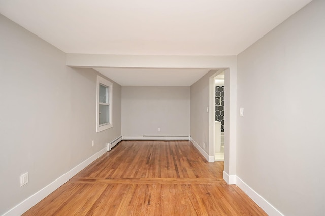 12 Barberry Ln, Middle Island, NY 11953 - spare room with light wood finished floors, baseboards, and a baseboard radiator