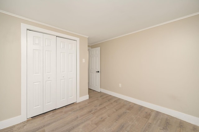 12 Barberry Ln, Middle Island, NY 11953 - unfurnished bedroom featuring light wood finished floors, baseboards, crown molding, and a closet