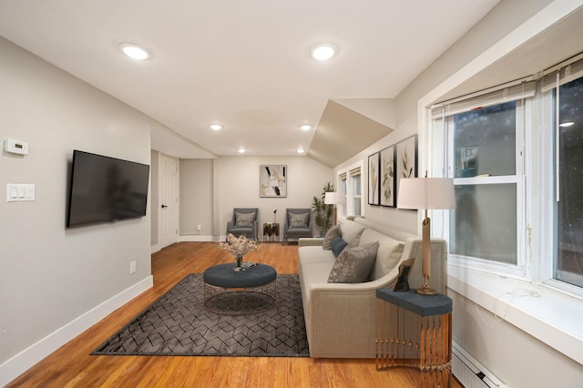 12 Barberry Ln, Middle Island, NY 11953 - living room featuring baseboard heating, wood finished floors, baseboards, vaulted ceiling, and recessed lighting