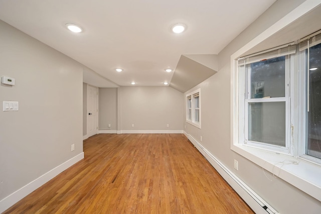 12 Barberry Ln, Middle Island, NY 11953 - unfurnished room featuring a baseboard radiator, light wood-style flooring, baseboards, recessed lighting, and vaulted ceiling