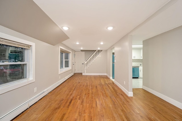 12 Barberry Ln, Middle Island, NY 11953 - unfurnished living room with a baseboard radiator, baseboards, light wood finished floors, stairway, and recessed lighting