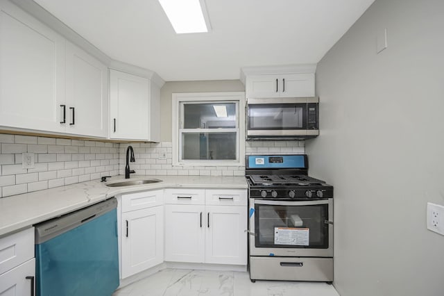 12 Barberry Ln, Middle Island, NY 11953 - kitchen featuring appliances with stainless steel finishes, a sink, tasteful backsplash, and white cabinets