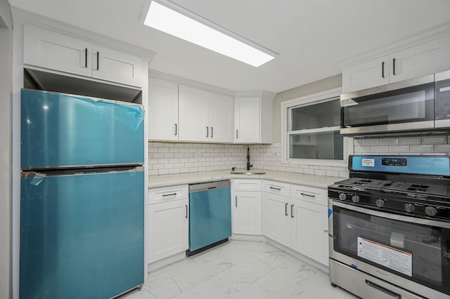 12 Barberry Ln, Middle Island, NY 11953 - kitchen featuring appliances with stainless steel finishes, light marble finish flooring, a sink, light countertops, and tasteful backsplash