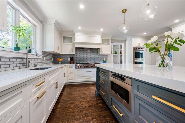 14 Pond Park Rd, Great Neck, NY 11023 - kitchen with stainless steel appliances, a sink, white cabinets, backsplash, and recessed lighting