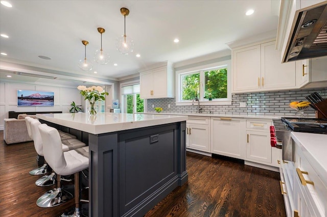 14 Pond Park Rd, Great Neck, NY 11023 - kitchen featuring range hood, dark wood finished floors, a breakfast bar area, white cabinetry, and recessed lighting