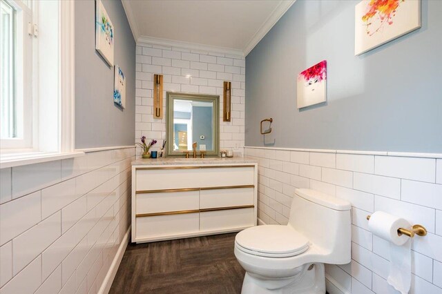 14 Pond Park Rd, Great Neck, NY 11023 - half bath with tile walls, ornamental molding, toilet, vanity, and a wainscoted wall