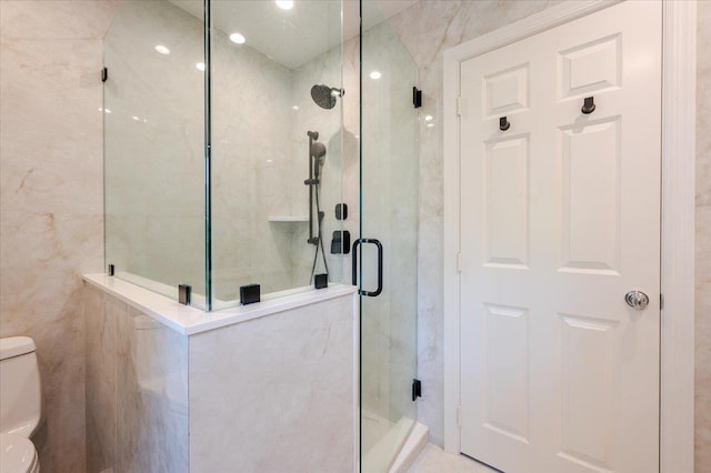 14 Pond Park Rd, Great Neck, NY 11023 - bathroom with toilet, a shower stall, and tile walls