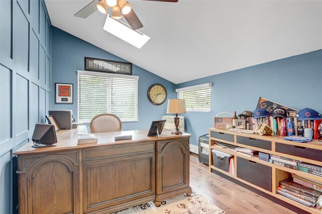 224 Biltmore Blvd, Massapequa, NY 11758 - office featuring a ceiling fan, a skylight, vaulted ceiling, light wood-style floors, and a baseboard heating unit