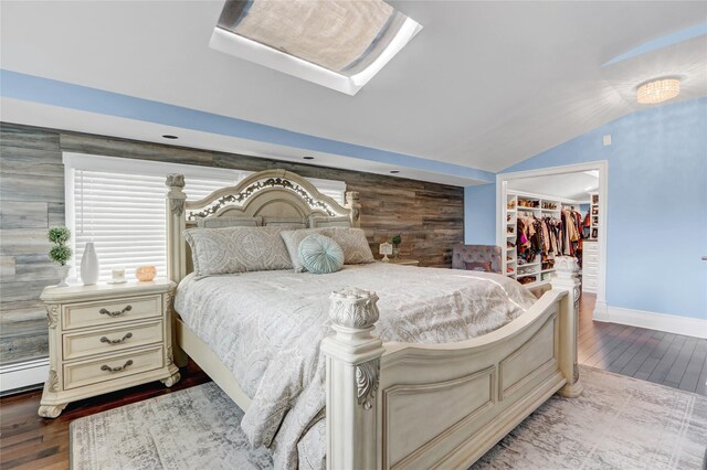 224 Biltmore Blvd, Massapequa, NY 11758 - bedroom with wood finished floors, a spacious closet, vaulted ceiling, baseboards, and a closet