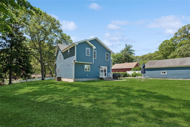 206 Brooksite Dr, Smithtown, NY 11787 - back of property featuring a lawn and cooling unit