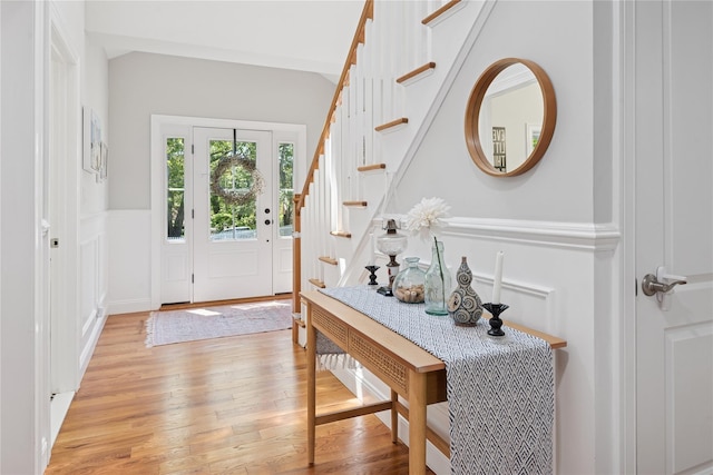 206 Brooksite Dr, Smithtown, NY 11787 - entrance foyer featuring light wood-style floors, a decorative wall, wainscoting, and stairs