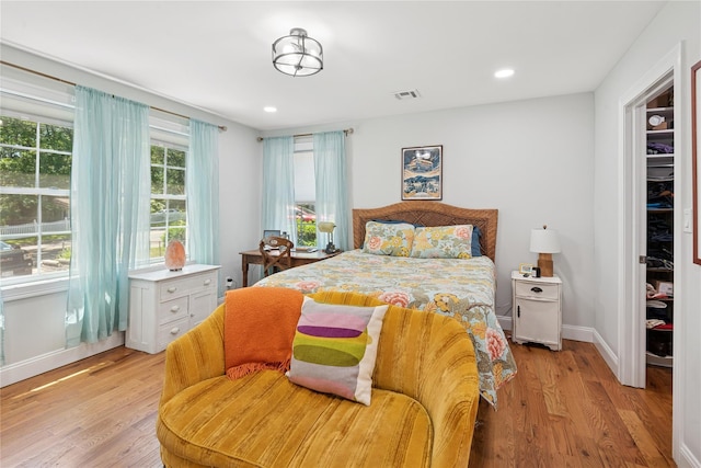 206 Brooksite Dr, Smithtown, NY 11787 - bedroom with light wood-type flooring, recessed lighting, a walk in closet, a closet, and baseboards