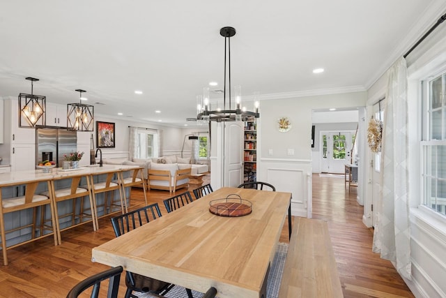 206 Brooksite Dr, Smithtown, NY 11787 - dining room featuring a decorative wall, a chandelier, crown molding, healthy amount of natural light, and a wainscoted wall