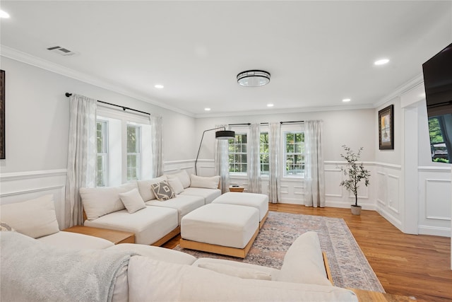 206 Brooksite Dr, Smithtown, NY 11787 - living room with plenty of natural light, a decorative wall, light wood-style flooring, and ornamental molding