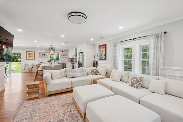 206 Brooksite Dr, Smithtown, NY 11787 - living room with crown molding, a chandelier, plenty of natural light, light wood finished floors, and recessed lighting