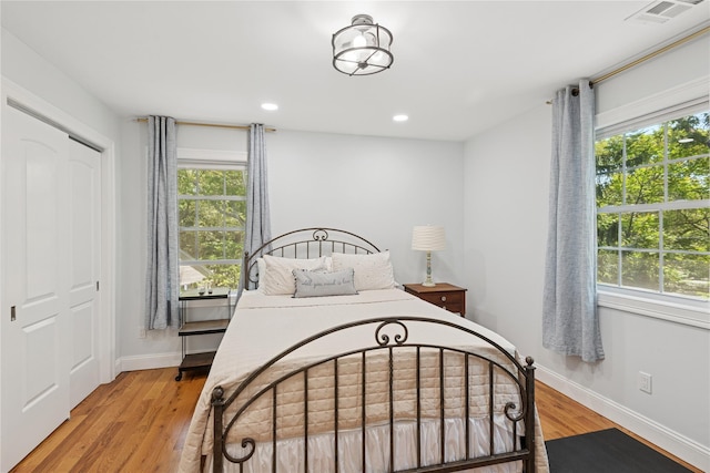 206 Brooksite Dr, Smithtown, NY 11787 - bedroom featuring multiple windows, light wood finished floors, baseboards, and recessed lighting