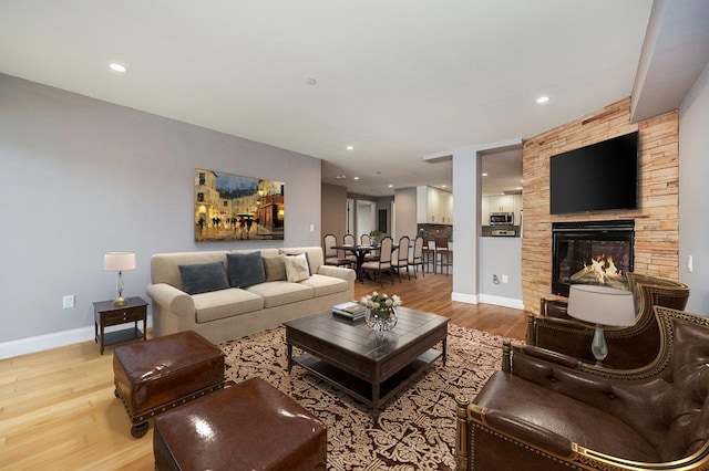 661 W Broadway Unit 203, Long Beach, NY 11561 - living area featuring light wood-style floors, baseboards, a fireplace, and recessed lighting