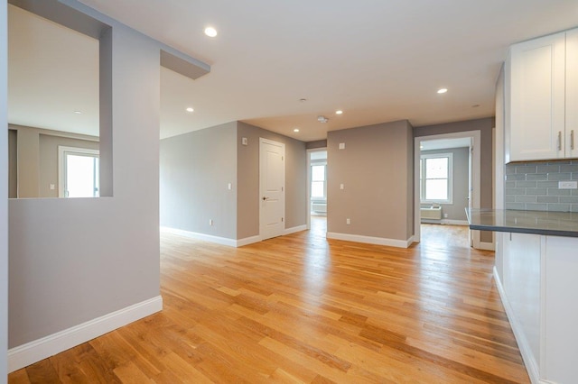 661 W Broadway Unit 203, Long Beach, NY 11561 - unfurnished living room with light wood finished floors, baseboards, and recessed lighting