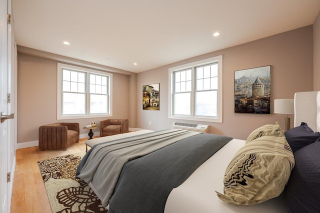 661 W Broadway Unit 203, Long Beach, NY 11561 - bedroom featuring wood finished floors, recessed lighting, baseboards, and a wall unit AC