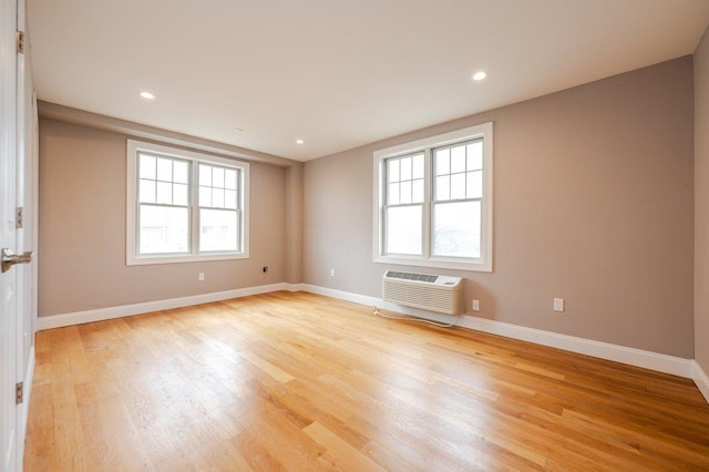 661 W Broadway Unit 203, Long Beach, NY 11561 - empty room featuring a wall unit AC, light wood-style flooring, baseboards, and recessed lighting