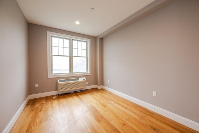 661 W Broadway Unit 203, Long Beach, NY 11561 - spare room with a wall unit AC, light wood-style flooring, baseboards, and recessed lighting