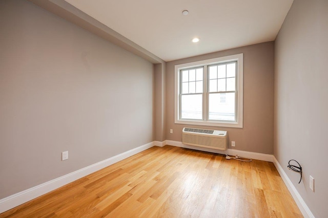 661 W Broadway Unit 203, Long Beach, NY 11561 - unfurnished room featuring a wall unit AC, light wood finished floors, baseboards, and recessed lighting